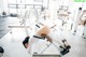 A woman is doing a bench press in a gym.