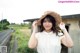 A woman in a straw hat is posing for a picture.