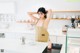 A woman standing in a kitchen next to a counter.