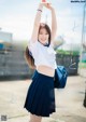 A woman in a school uniform is posing for a picture.